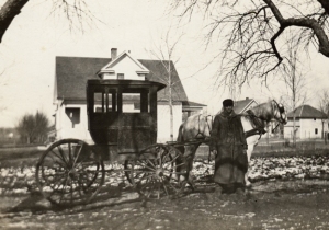 Mr. Ebinger, a rural mail carrier working out of the Oswego Post Office about 1915, pauses after completing his rounds. 