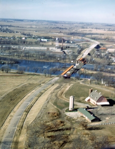 Aerial shot taken by Bev Skaggs in the spring of 1959 of the construction of Paul Egan's By-Pass bridge and Boulder Hill Playhouse. It's lack of sharpness is more than made up for by it's subject matter. (Little White School Museum collection)